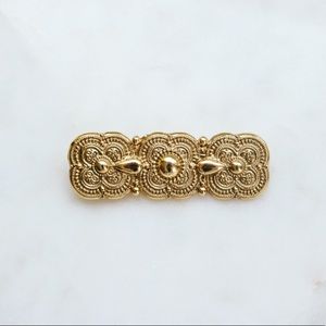 Ornate gold brooch